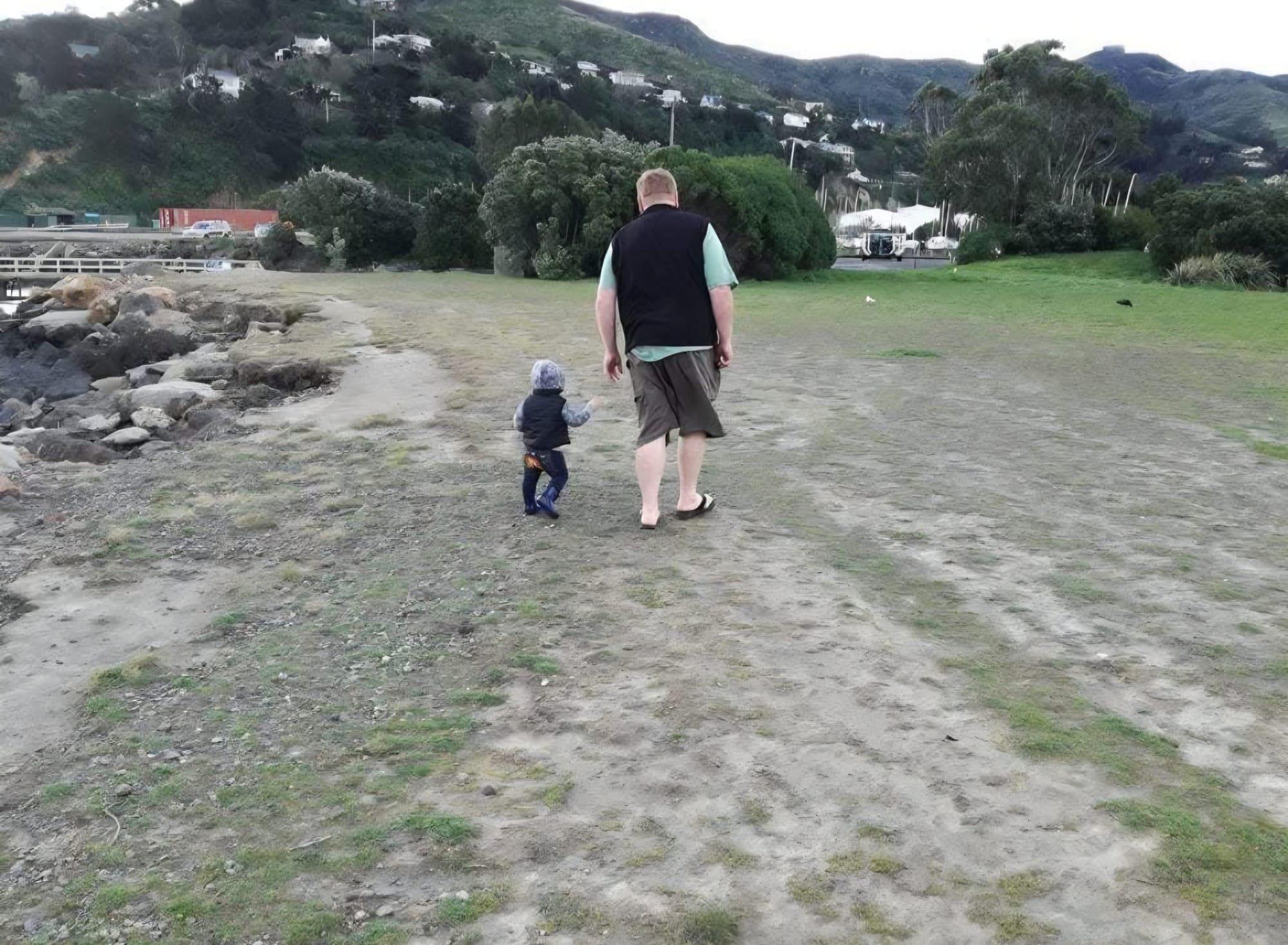 Simon Gilby walks with one of his children. 