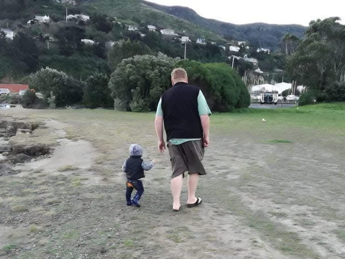 Simon Gilby walks with one of his children. 