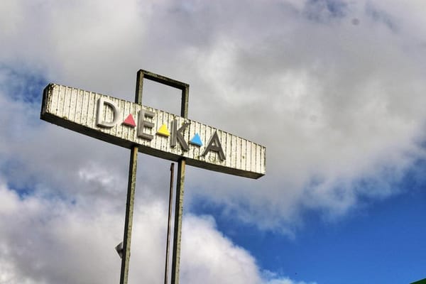The DEKA sign in Huntly, with a blue sky with white clouds in the background